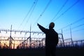 electricity workers and pylon silhouette Royalty Free Stock Photo