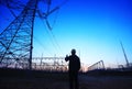 electricity workers and pylon silhouette Royalty Free Stock Photo