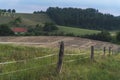 Electrified fence surrounding farmland at dawn