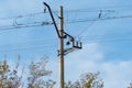 Electrified railway pole on blue sky background. Royalty Free Stock Photo