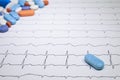 Electrocardiogram with Brugada syndrome. Colored pills on an EKG path. Sudden cardiac death due to arrhythmias