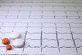 Electrocardiogram with Brugada syndrome. Colored pills on an EKG path. Sudden cardiac death due to arrhythmias