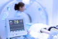 Electrocardiogram in hospital CT Scan room. heart rate monitor in hospital. Process of CT scanning of an old patient. Man Receivin