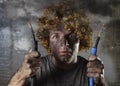 Electrocuted man with cable smoking after domestic accident with dirty burnt face shock electrocuted expression