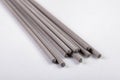 Electrodes for electric welding on a white workbench. Welding accessories for MMA methods Royalty Free Stock Photo