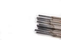 Electrodes for electric welding on a white workbench. Welding accessories for MMA methods Royalty Free Stock Photo