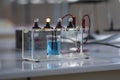 Electrolyte solution turns on a light bulb. Experiment in the chemistry laboratory Royalty Free Stock Photo