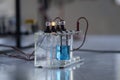 Electrolyte solution turns on a light bulb. Experiment in the chemistry laboratory Royalty Free Stock Photo