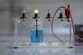 Electrolyte solution turns on a light bulb. Experiment in the chemistry laboratory Royalty Free Stock Photo