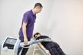 Electromagnetic therapy of the back. Physiotherapist doctor uses medical equipment for highly effective pain treatment and