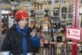 Electromechanic in electrical safety gloves holds power cable, cabling connection of high voltage power electric line in