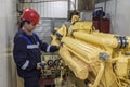 Electromechanic performs repair work on a diesel generator