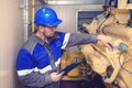 Electromechanic performs repair work on a diesel generator