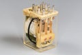 Electromechanical coil relay in transparent dust cover on gray background Royalty Free Stock Photo