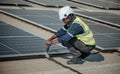 Electromechanical solar panel technician install, assemble photovoltaic systems on roof based on site assessment and schematic Royalty Free Stock Photo