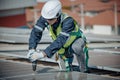 Electromechanical solar panel technician install, assemble photovoltaic systems on roof based on site assessment and schematic Royalty Free Stock Photo