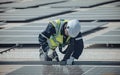 Electromechanical solar panel technician install, assemble photovoltaic systems on roof based on site assessment and schematic Royalty Free Stock Photo