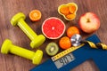 Electronic bathroom scale, centimeter and stethoscope, fresh fruits, dumbbells for fitness, slimming and healthy lifestyles concep Royalty Free Stock Photo