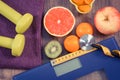 Electronic bathroom scale, centimeter and stethoscope, fresh fruits, dumbbells for fitness, slimming and healthy lifestyles Royalty Free Stock Photo