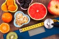 Electronic bathroom scale, centimeter and stethoscope, healthy food, slimming and healthy lifestyles concept Royalty Free Stock Photo