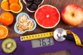 Electronic bathroom scale, centimeter and stethoscope, healthy food, slimming and healthy lifestyles concept Royalty Free Stock Photo