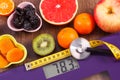 Electronic bathroom scale, centimeter and stethoscope, healthy food, slimming and healthy lifestyles concept Royalty Free Stock Photo