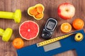 Electronic bathroom scale, glucometer, centimeter, healthy food and dumbbells for fitness, healthy lifestyles, diabetes and Royalty Free Stock Photo