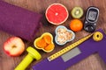 Electronic bathroom scale, glucometer, centimeter, healthy food and dumbbells for fitness, healthy lifestyles, diabetes and slimmi Royalty Free Stock Photo