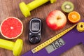 Electronic bathroom scale and glucometer with result of measurement, centimeter, healthy food and dumbbells, healthy lifestyles, d Royalty Free Stock Photo