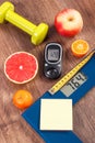 Electronic bathroom scale and glucometer with result of measurement, centimeter, healthy food and dumbbells, healthy lifestyles, d Royalty Free Stock Photo