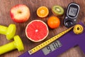 Electronic bathroom scale and glucometer with result of measurement, centimeter, healthy food and dumbbells, healthy lifestyles Royalty Free Stock Photo