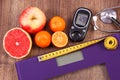 Electronic bathroom scale and glucometer with result of measurement, centimeter, stethoscope and healthy food, healthy lifestyles, Royalty Free Stock Photo