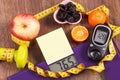 Electronic bathroom scale and glucometer with result of measurement, healthy food and dumbbells, healthy lifestyles, diabetes and Royalty Free Stock Photo
