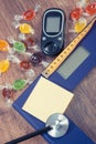 Electronic bathroom scale, glucometer, stethoscope and centimeter with colorful candies, diabetes, slimming and reduction eating