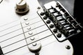 Electronic black and white guitar body close up with pickups and control knobs. Royalty Free Stock Photo