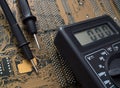 Electronic board and multimeter Royalty Free Stock Photo