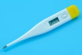 The electronic body thermometer displays a very high temperature of 39.9 ÃÂ° C Celsius on a blue background