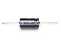 Electronic capacitor with a rating of 470 microfarads and 63 volts Royalty Free Stock Photo