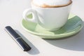 electronic cigar and cup of cappuccino Royalty Free Stock Photo