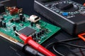 Electronic circuit board and digital multimeter Royalty Free Stock Photo