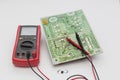Electronic circuit board and multimeter Royalty Free Stock Photo