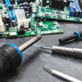 Electronic Circuit Board Repair Tools on a Grey Surface Close Up View Royalty Free Stock Photo