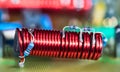 Electronic coil with ferrite core and blue small color coded resistors on red copper wire Royalty Free Stock Photo
