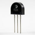Electronic Component F228 Triode Transistor on White Background semiconductor Royalty Free Stock Photo