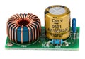 Electronic component featuring a transformer and a capacitor on a circuit board Royalty Free Stock Photo