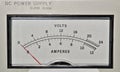 Electronic DC power supply with needle display in volts and amperes.