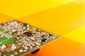 electronic device, green circuit or motherboard on orange yellow background Royalty Free Stock Photo