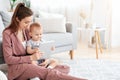 Electronic Devices For Babies. Mom And Toddler Son Using Digital Tablet At Home Royalty Free Stock Photo