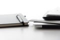Electronic devices and notebook on white table surface Royalty Free Stock Photo