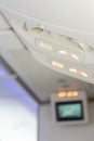 Electronic devices off and fasten seat belt sign inside airplane Royalty Free Stock Photo